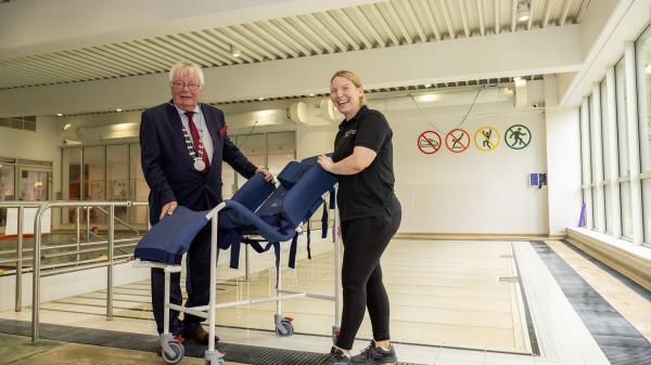 The Mayor of the County of Cork, Cllr. Joe Carroll with Yvonne Buckley, Acting Manager at West Cork Leisure Centre - Dunmanway unveiling a new accessible chair at West Cork Leisure Centre – Dunmanway.