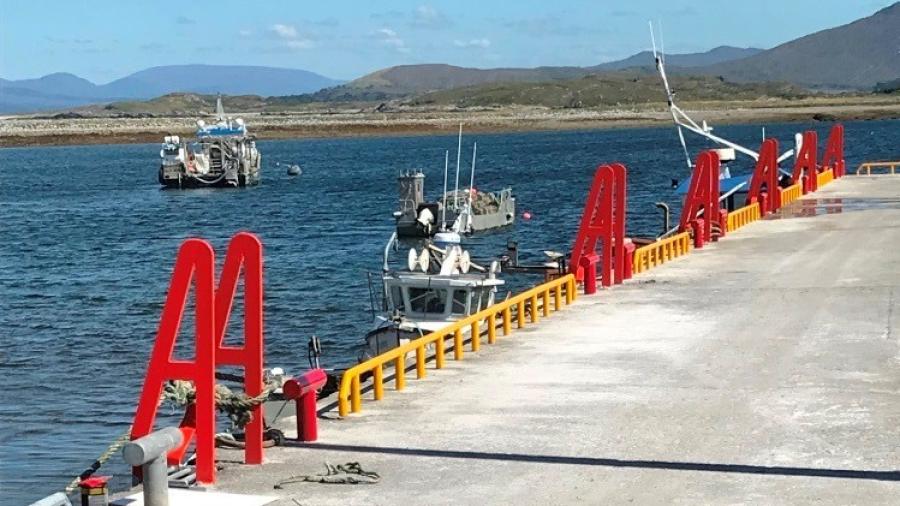 boats in the water alongside a pier