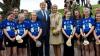 A group of camogie players and a man and a woman