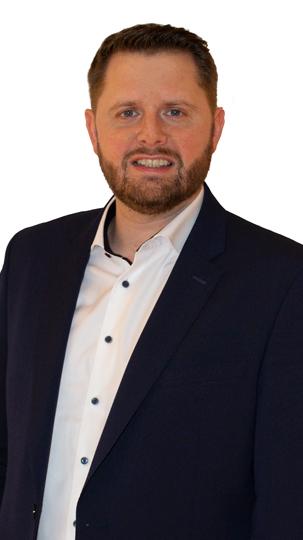 Man in a navy suit jacket and white shirt.