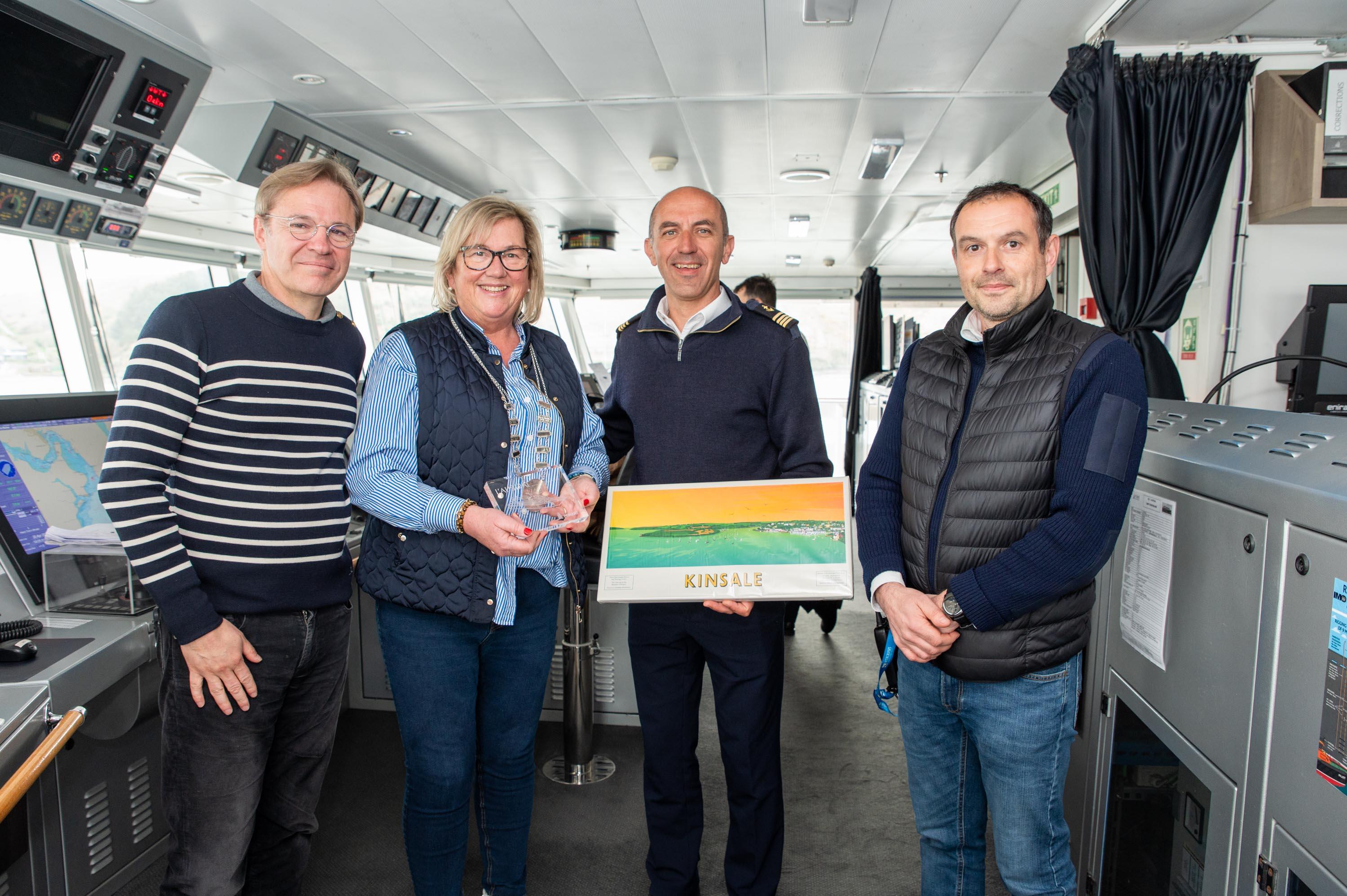 Cllr. Marie O’Sullivan, Chair of the Bandon Kinsale District and Cork County Council's senior harbour master Julian Renault exchanging gifts with the President of Ponant Cruises Hervé Gastinel and the ships captain Stanislas Devorsine on the bridge of the expedition cruise liner L’Austral which visited Kinsale last week. 