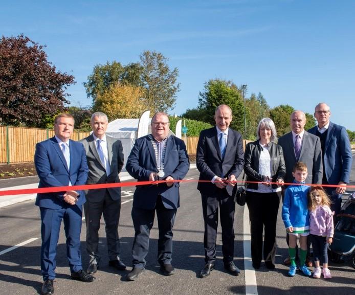 A group of people cutting a ribbon