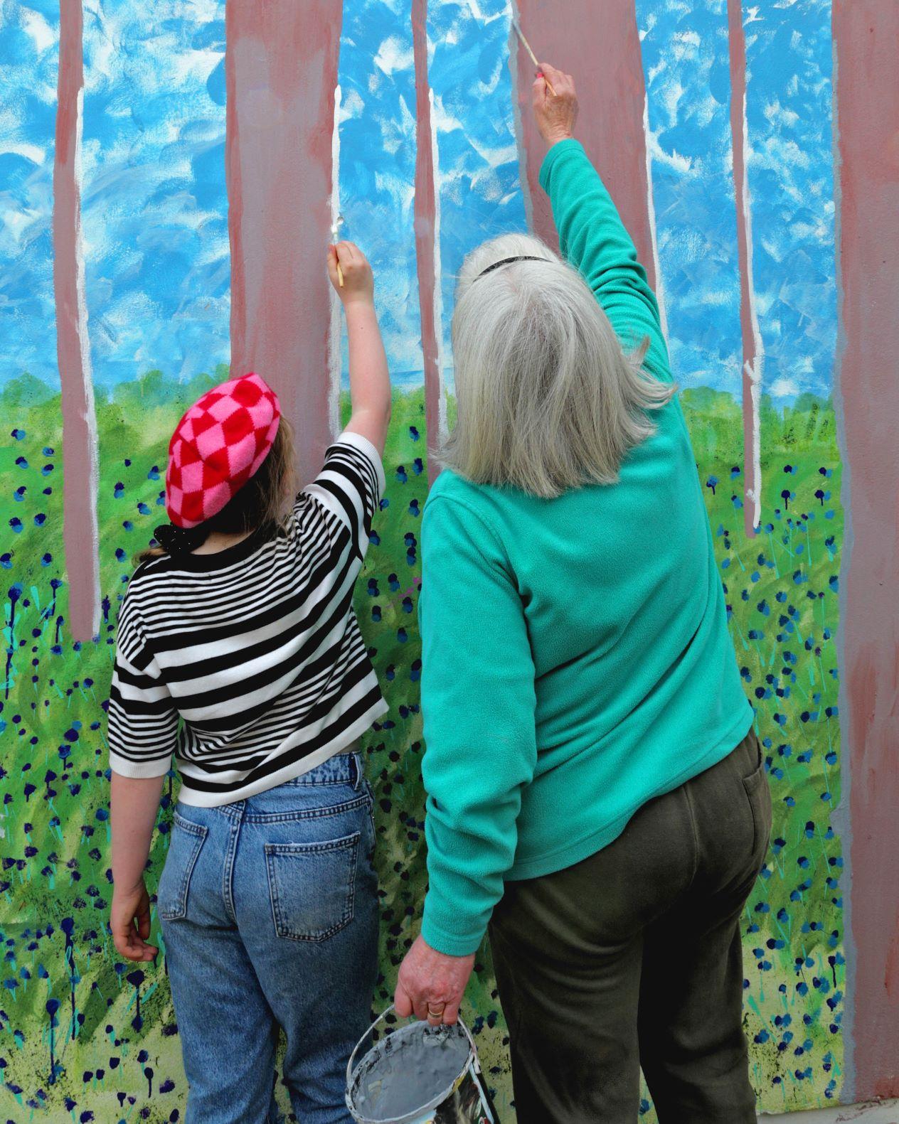 Two people painting