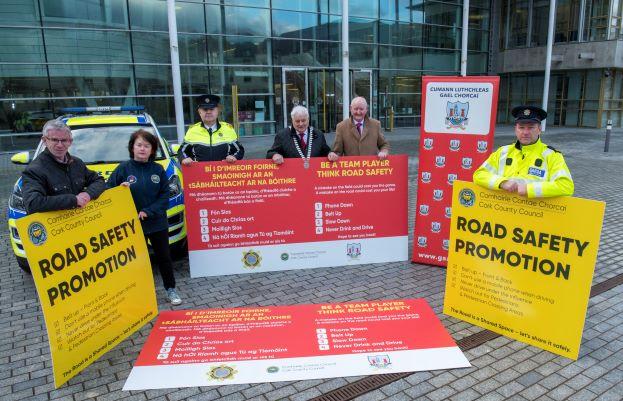 A group of people holding up promotional signs