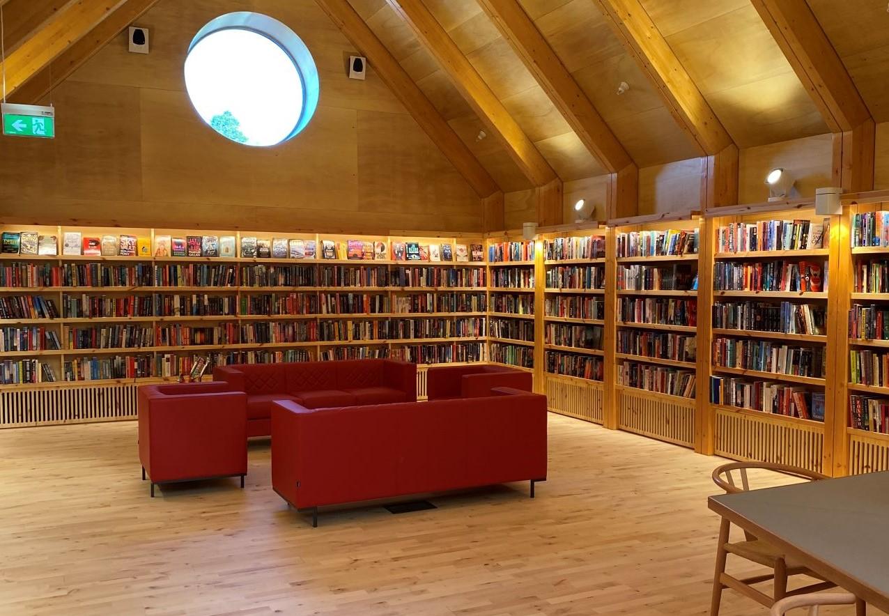 Library bookshleves with red chairs