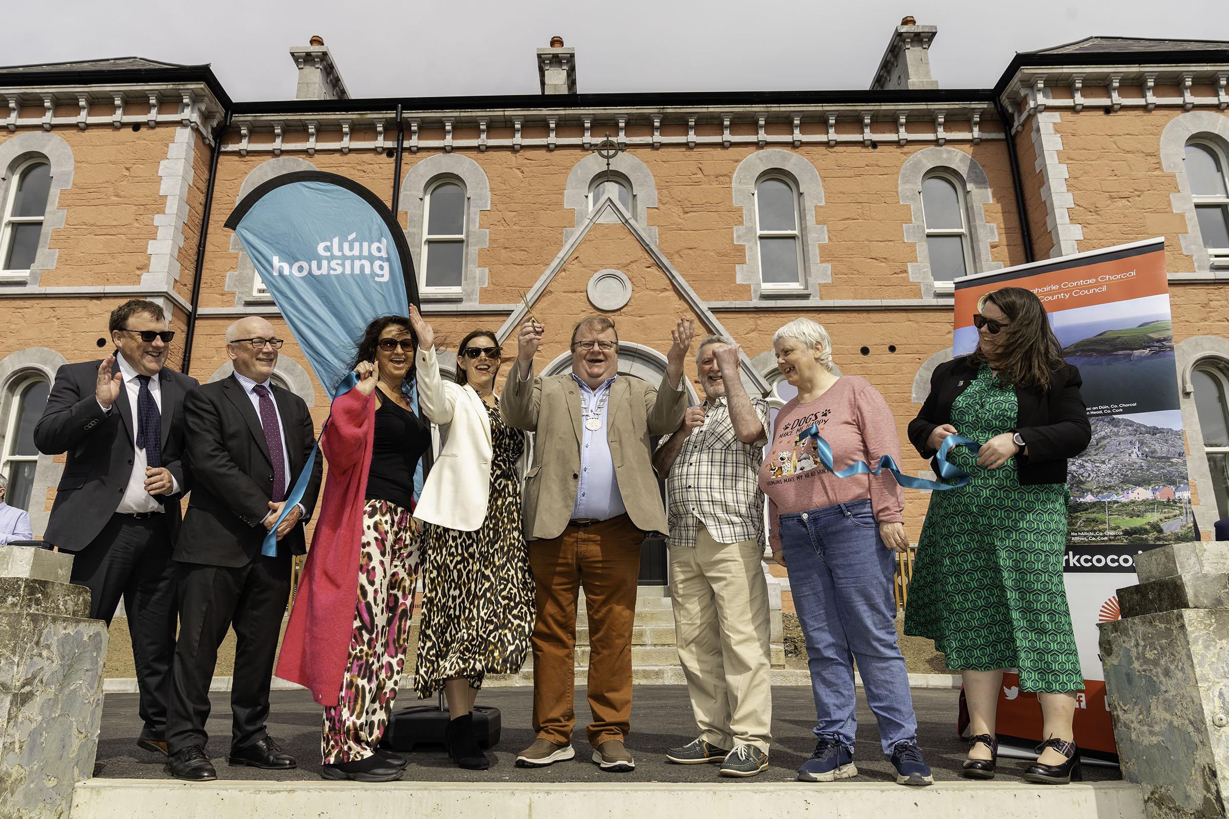 A group of people cutting a ribbon