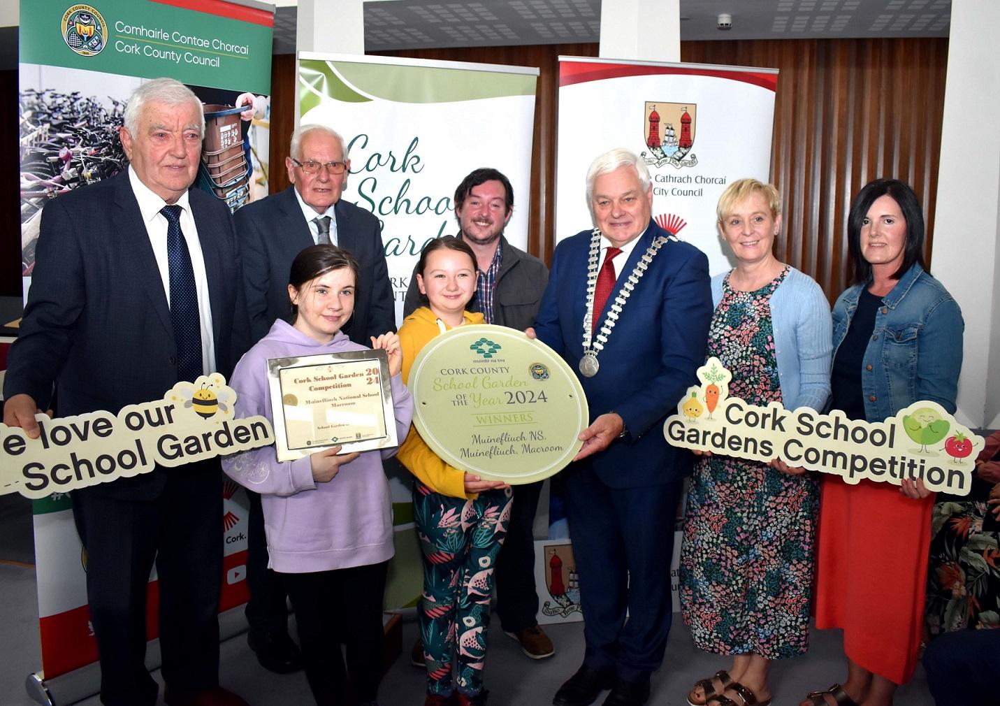 Mayor of the County of Cork, Cllr. Frank O'Flyn along with three other men and two women presenting an award to the winners of the Schools Garden competition.