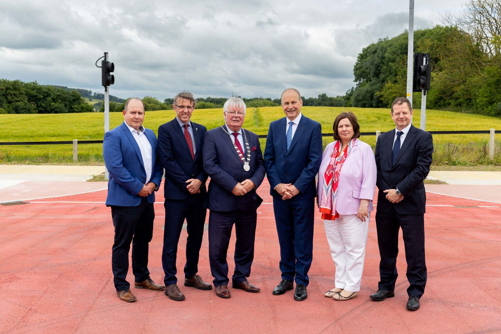 A group of people in suit near a new road