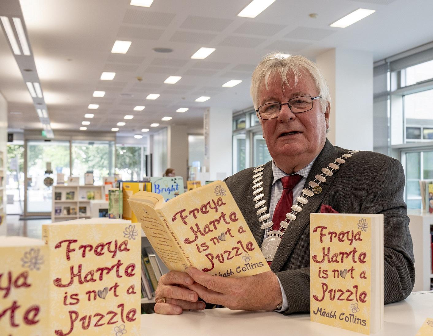 Mayor of the County of Cork, Cllr. Joe Carroll reading 'Freya Harte is Not a Puzzle'.