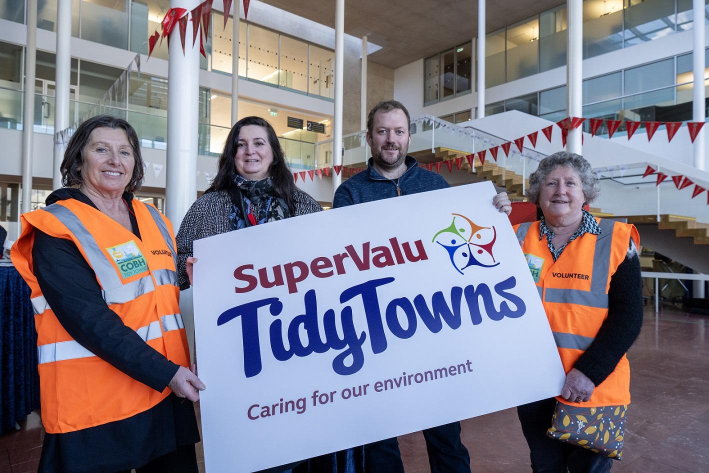 Members of Tidy Towns holding a Tidy Towns banner.