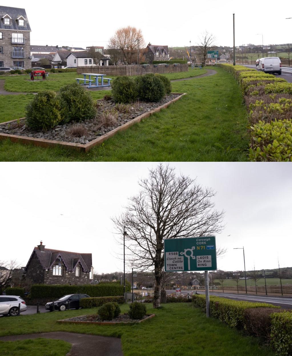 A suburban roadside scene with grassy and landscaped areas, featuring a playground, stone buildings, and directional road signs.